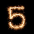 Symbol of number five made with sparks on a black background