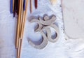 Symbol OM with clay on the desk.