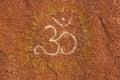 The symbol OM is drawn on a tamboo. Buddhism, yoga, zen. Rock dr