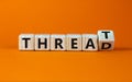 Symbol for online hate. Turned a cube and changed the word `threat` to `thread`. Beautiful orange background. Concept. Copy sp