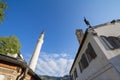 Minaret of the Gazi Husrev begova Mosque next to the clocktower of Sarajevo bazaar, called Bascarsija, in Bosnia and Herzegovina. Royalty Free Stock Photo