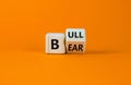 Symbol for a positive trend at the stock market. Turned a cube and changed the word `bear` to `bull`. Beautiful orange backgro Royalty Free Stock Photo