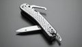 Metallic Multi-Tool Pocket Knife on Dark Background Royalty Free Stock Photo