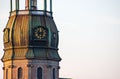 Symbol of Riga, old clock on medieval church tower among roofs ancient buildings with European architecture Royalty Free Stock Photo
