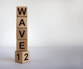 Symbol for a second wave of the corona virus. Cube with the changed the expression `1 wave` to `2 wave`. Copy space. Beautiful Royalty Free Stock Photo