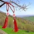 The symbol of spring white and red is a martisor in the form of a cross on a tree. Handmade folklore martenica, for good Royalty Free Stock Photo