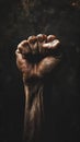 A symbol of strength and struggle, a dirty fist clenched and uplifted, set against a black backdrop black history month Royalty Free Stock Photo