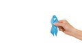 Symbol for support men. Close up of female hand hold blue ribbon,  over white studio background wall with copy space. Royalty Free Stock Photo