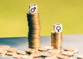 Symbol for unequal payment. Gender symbols on different high stacks of coins