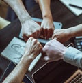 Symbol of unity within business team. Members of team form circle, raising fists in gesture of solidarity and Royalty Free Stock Photo