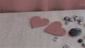 Symbol for valentine\'s day. two wooden hearts, gray pebbles