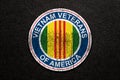 Symbol of the Vietnam Veterans of America on black textured background. Vietnam Veterans Day.