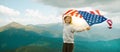 The symbol of woman with the flag of USA stands on the top of the mountain Royalty Free Stock Photo