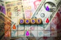 A symbol with the words Debt on a dice placed on the banknote and calendar backgrounds Royalty Free Stock Photo