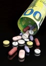 Various pills and euro bill - medicines and costs