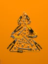 A symbolic Christmas tree made of construction tools on a yellow background.