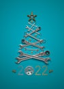 A symbolic Christmas tree made of wrenches, bolts and nuts on a blue background. Royalty Free Stock Photo