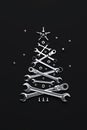 A symbolic Christmas tree made of wrenches, bolts and nuts on a dark background. Royalty Free Stock Photo