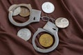 Symbolic coins of bitcoin and stack of bitcoin coins and metall handcuffs on banknotes of one hundred dollars. Exchange