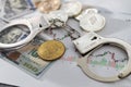 Symbolic coins of bitcoin and stack of bitcoin coins and metall handcuffs on banknotes of one hundred dollars. Exchange