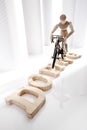 Symbolic for doping: Wooden figurine on racing cycle Royalty Free Stock Photo