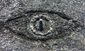 Symbolic eye made out of stones and carved sand on a summer pebble beach - Concept of big brother or omnipresence of God
