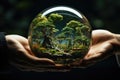 Symbolic glass ball with green plants is passed from one person to another. Care and respect for nature