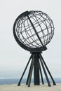 The symbolic globe at the North Cape point in a cloudy weather day in North Cape, Norway. Royalty Free Stock Photo