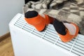 A child with a woolen blanket warms his feet over an electric heater. Royalty Free Stock Photo