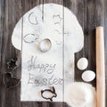 Symbolic image Easter cake with utensils on a dark wooden background.