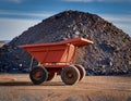 A symbolic image of an empty mining cart beside a heap of unmined rock, highlighting the potential of untouched natural resources