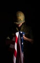 Symbolic image of Vietnam War veteran soldier holding the American flag. Royalty Free Stock Photo