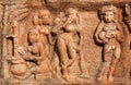 Symbolic image of a woman in the kitchen, with a child - the stone relief of 7th century temple in Badami town, India.