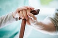 Symbolic photo with hands - young helping elder one