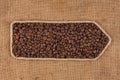 Symbolic pointer made of rope with coffee beans lying on a burlap Royalty Free Stock Photo