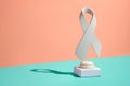 Symbolic pure white ribbon trophy over a bicolor background