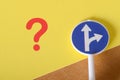 Symbolic Road Choices: Question Mark and Direction Sign Representing Uncertainty Royalty Free Stock Photo