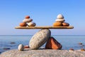 Symbolic scales of the stones against the sea. Pros and cons concept