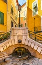 Stone stairs and fountain at Rue du Poilu street and Place du Conseil square in old town of Villefranche-sur-Mer resort in France
