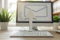 Symbolic white envelope with arrow pointing to computer screen email delivery concept