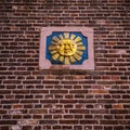 Symbolical images on an old brick wall of city building.