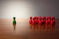 Symbolism wooden red and green figures for business exclusion racism mobbing hate religions