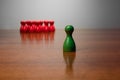 Symbolism wooden red and green figures for business exclusion racism mobbing hate religions