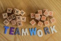 Symbolizing teamwork with wooden blocks and colored letters with