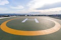 Symbols for helicopter parking on the roof of an office building. Empty square front of city skyline. Offshore helicopter parking Royalty Free Stock Photo