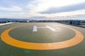 Symbols for helicopter parking on the roof of an office building. Empty square front of city skyline. Offshore helicopter parking Royalty Free Stock Photo