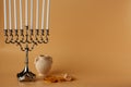 Image of jewish holiday Hanukkah with menorah and wooden dreidel, jug, coins Royalty Free Stock Photo