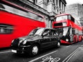 Symbols of London, the UK. Red buses, black taxi cab. Black and white Royalty Free Stock Photo