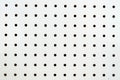 Symetrical holes on a white pegboard