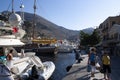 The charming Greek island of Symi. Holiday makers stroll along the quayside.